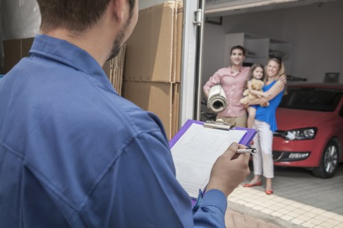 Local removal team loading household items into a van