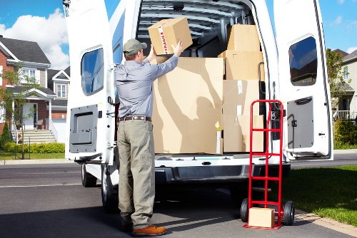 Movers carrying furniture carefully through a property