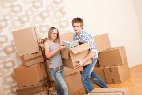 Removal team carrying furniture through a Lower Morden property